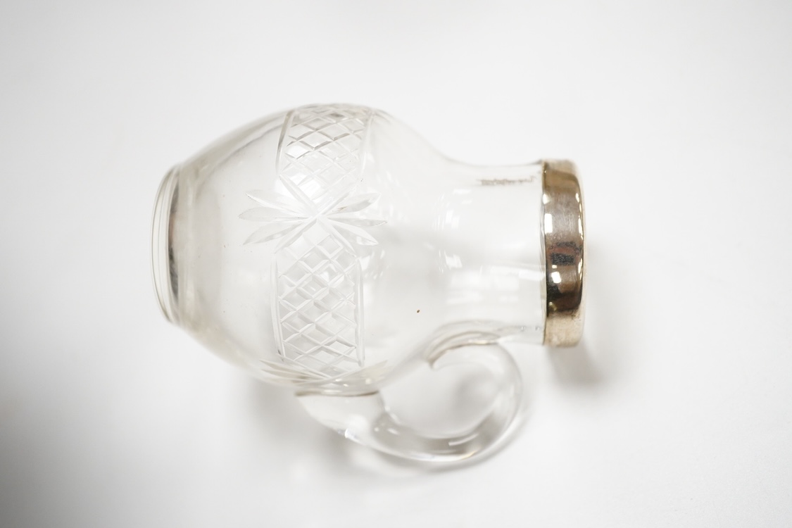 A George VI silver sugar bowl, Viners Ltd, Sheffield, 1946, diameter 10.9cm, together with a cased silver spoon & pusher and a silver mounted glass liquor jug.
